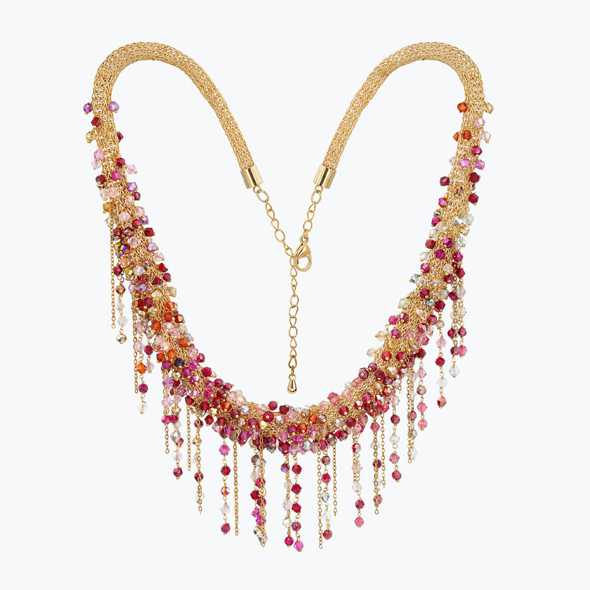 Handknitted wire collar necklace with ruby, crimson, pink, and clear individually hanging crystals on gold mesh.