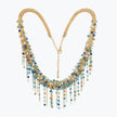 Handknitted wire collar necklace in gold with blue, turquoise, and white individually hanging crystals.