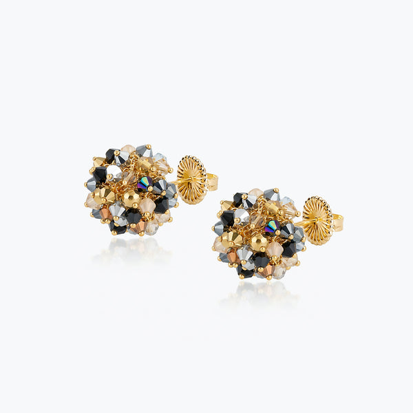 Gold stud earrings with black, silver, and bronze reflective crystals on handknitted wire.