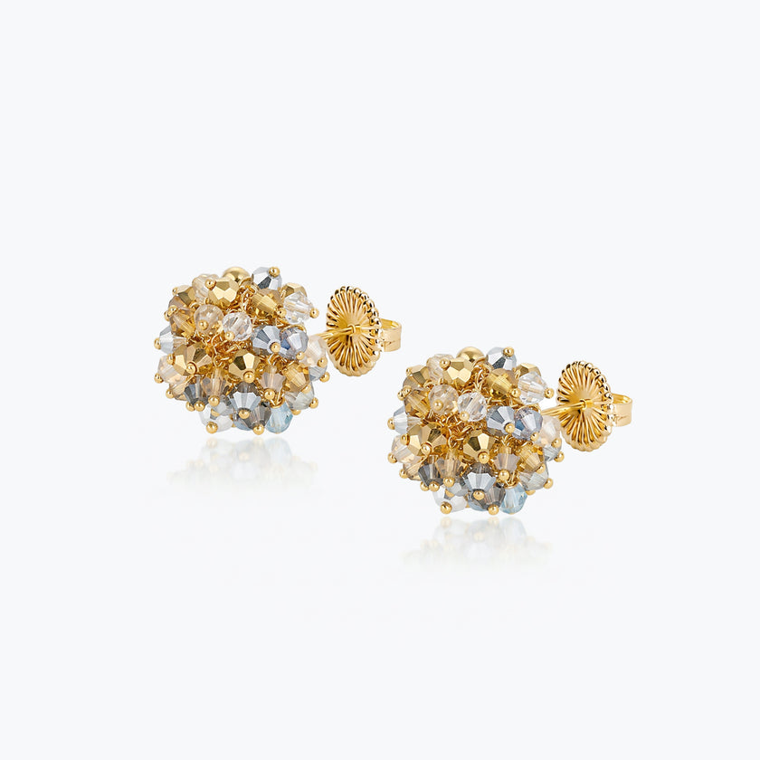 Gold hemisphere stud earrings featuring reflective gold crystals handknitted into a textured ball.