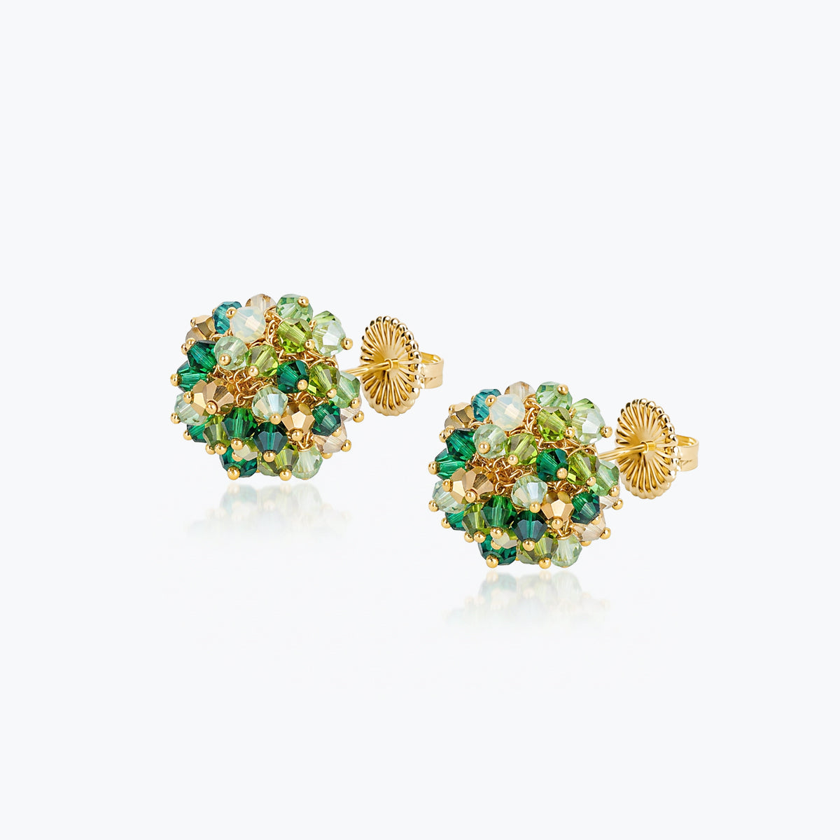 Handknitted wire mesh ball stud earrings in gold featuring green premium crystals.