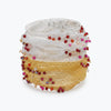 Silver gold distorted cuff bracelet showing a slender handknitted wire structure finished with rows of pink and red crystals.