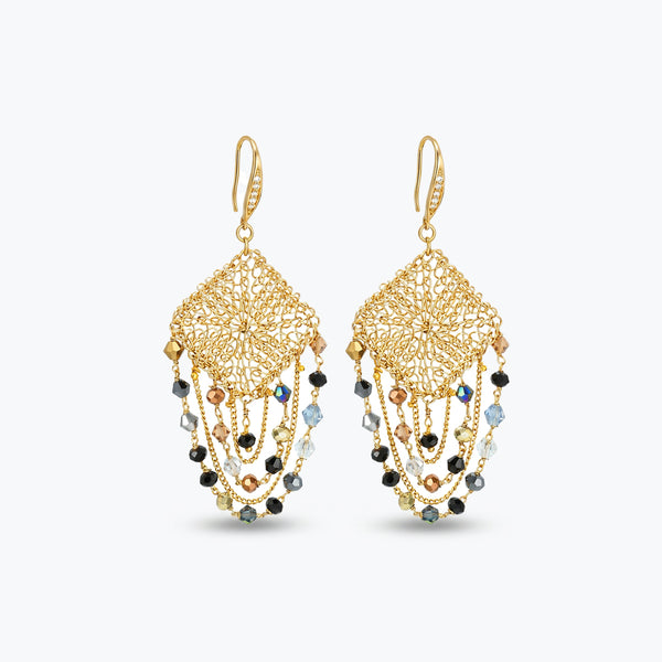 Gold drop earrings with a diamond handknitted wire mesh square panel and draped chains of bronze, grey, and black crystals.