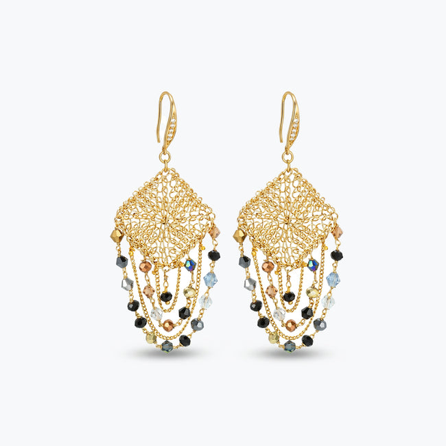 Gold drop earrings with a diamond handknitted wire mesh square panel and draped chains of bronze, grey, and black crystals.