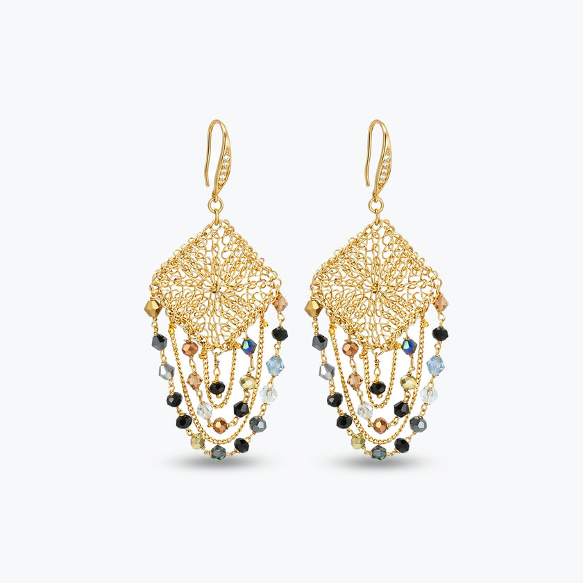 Gold drop earrings with a diamond handknitted wire mesh square panel and draped chains of bronze, grey, and black crystals.