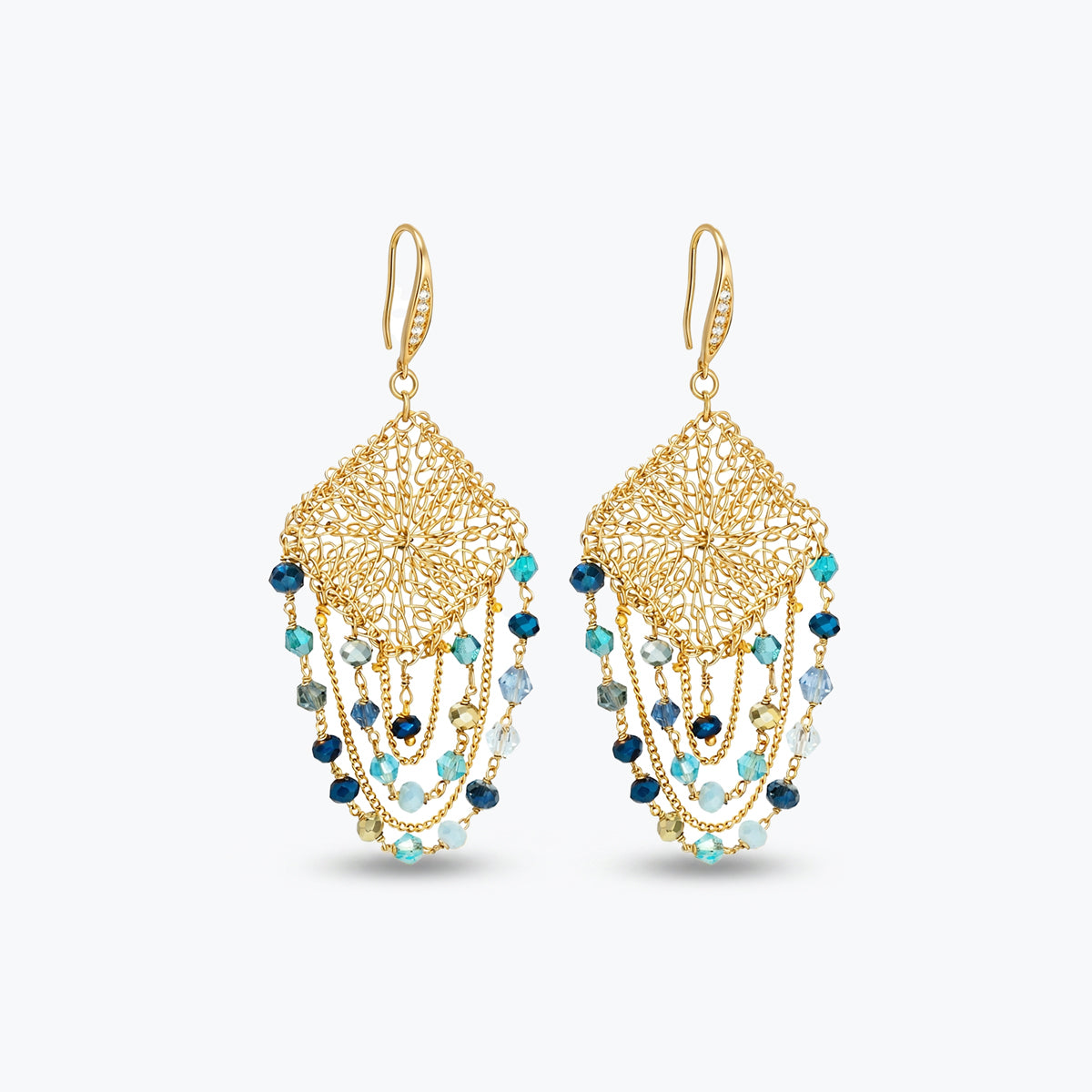 Gold drop earrings with a diamond-shaped handknitted wire mesh square panel and cascading strands of blue reflective crystals.
