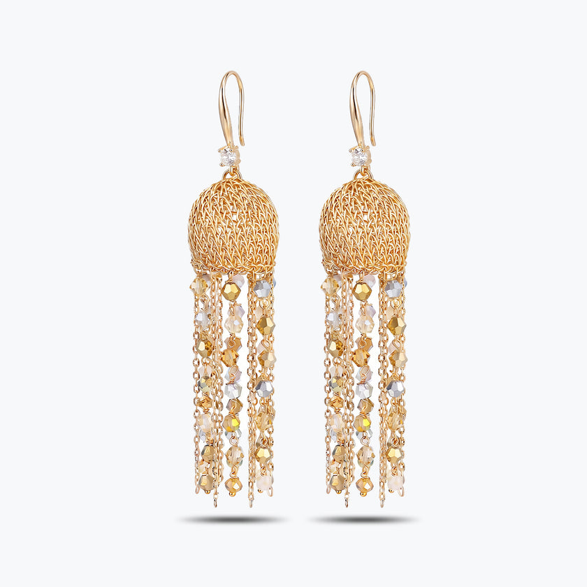 Gold drop earrings featuring a spherical handknitted wire mesh cap and straight tassel lines of clear premium crystals.