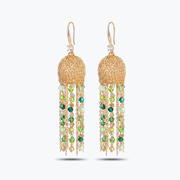 Gold drop earrings showcasing a round handknitted wire sphere with long hanging tassel chains of green crystals.