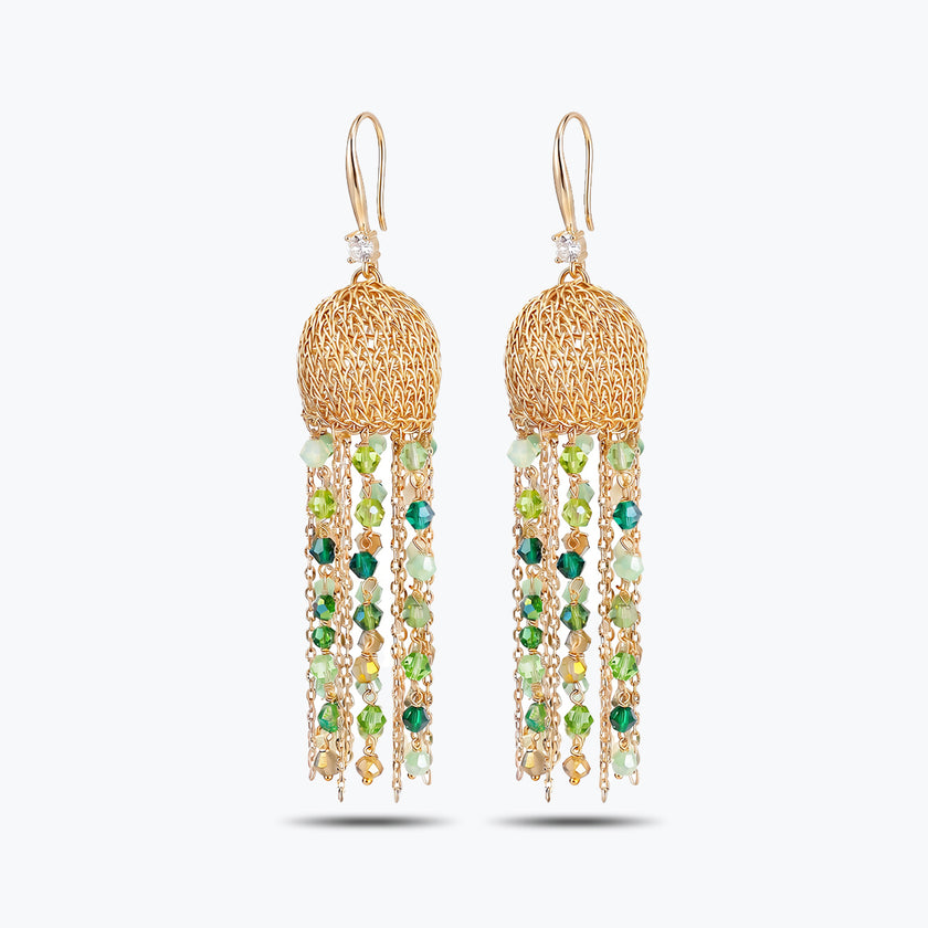 Gold drop earrings showcasing a round handknitted wire sphere with long hanging tassel chains of green crystals.