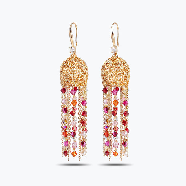 Gold drop earrings with a handknitted wire sphere and elegant linear tassel strands of vibrant red crystals.