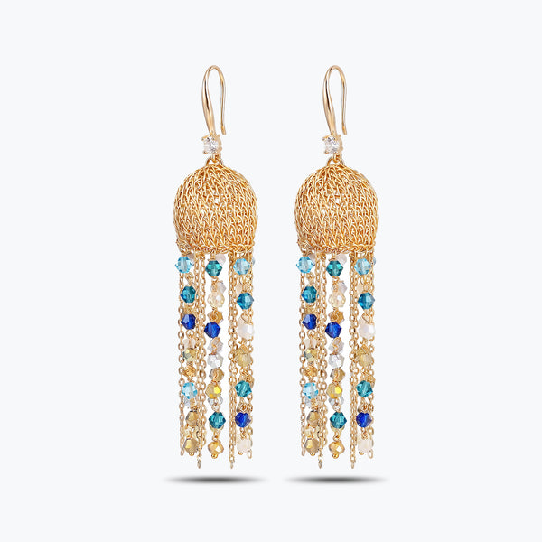 Gold drop earrings with a round, spherical handknitted wire top and long tassel strands of blue reflective crystals.
