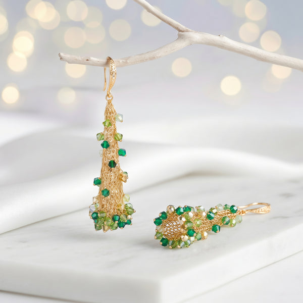 Conical earrings made of handknitted wire mesh featuring reflective crystals in shades of green and gold.