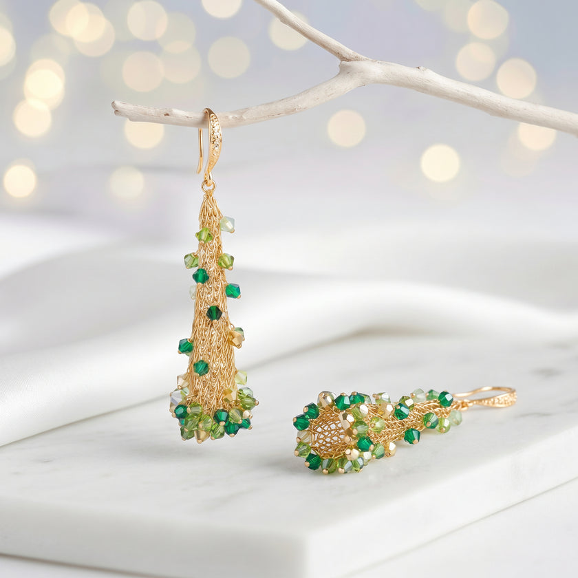 Conical earrings made of handknitted wire mesh featuring reflective crystals in shades of green and gold.
