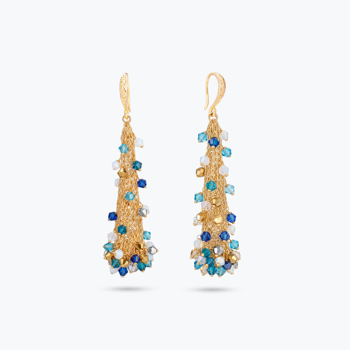 Long cone earrings in handknitted wire mesh adorned with colorful blue, white, and gold crystals.