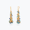 Long cone earrings in handknitted wire mesh adorned with colorful blue, white, and gold crystals.