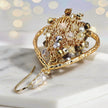 Gold drop earrings showcasing a handknitted wire mesh teardrop shape with hanging champagne and clear premium crystals.