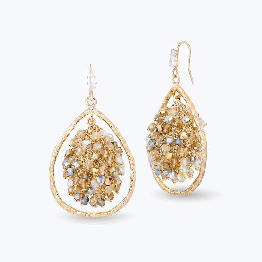 Gold drop earrings showcasing a handknitted wire mesh teardrop shape with hanging champagne and clear premium crystals.