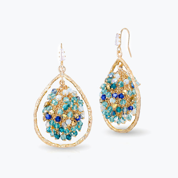 Gold drop earrings featuring a  handknitted wire mesh teardrop shape with dangling blue and silver premium crystals.