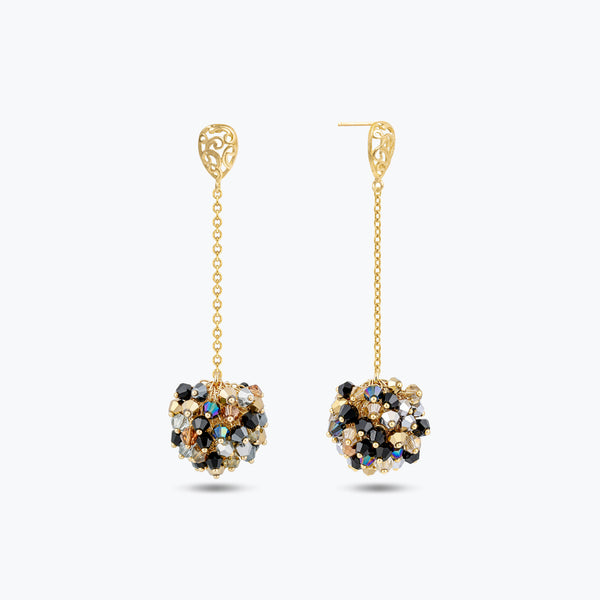 Gold drop earrings featuring a handknitted wire mesh ball with hanging bronze, gray, and black premium crystals.
