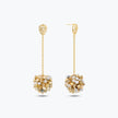 Gold drop earrings displaying a  handknitted wire mesh ball and clusters of clear and gold premium crystals.
