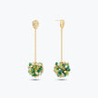 Gold drop earrings with a handknitted wire mesh ball accent holding individually hanging green and teal crystals.
