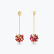 Gold drop earrings showcasing a handknitted wire mesh ball  filled with hanging pink and red crystals.
