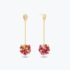 Gold drop earrings showcasing a handknitted wire mesh ball  filled with hanging pink and red crystals.
