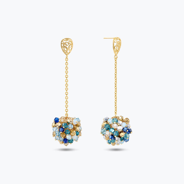 Gold drop earrings featuring a handknitted wire ball with suspended blue and silver reflective crystals.
