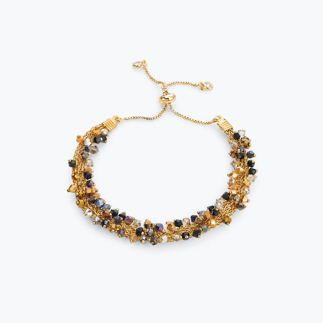 Gold handknitted wire slider bracelet featuring reflective crystals in bronze, gold, hematite black, and silver.