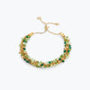 Gold handknitted wire slider bracelet displaying green, emerald, mint, and gold premium crystals.