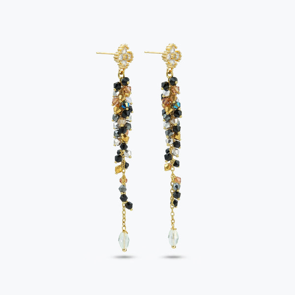 Gold drop earrings displaying a sleek handknitted wire vertical frame decorated with gray and black premium crystals.
