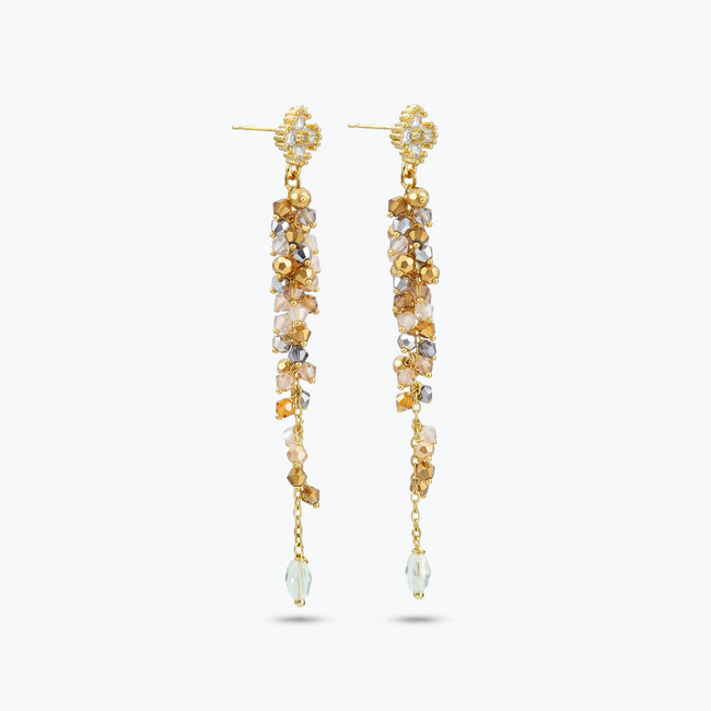 Gold drop earrings featuring a long linear handknitted wire design with hanging champagne and clear premium crystals.
