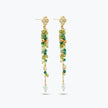 Gold drop earrings with a vertical handknitted wire mesh strip trailing down into green individually hanging crystals.
