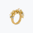 Gold statement ring featuring champagne and clear reflective crystals woven into a cluster.