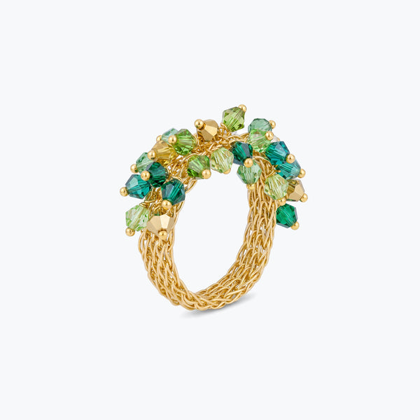 Gold ring with a vibrant cluster of green and gold premium crystals clustered on woven wire mesh.