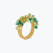 Gold ring with a vibrant cluster of green and gold premium crystals clustered on woven wire mesh.