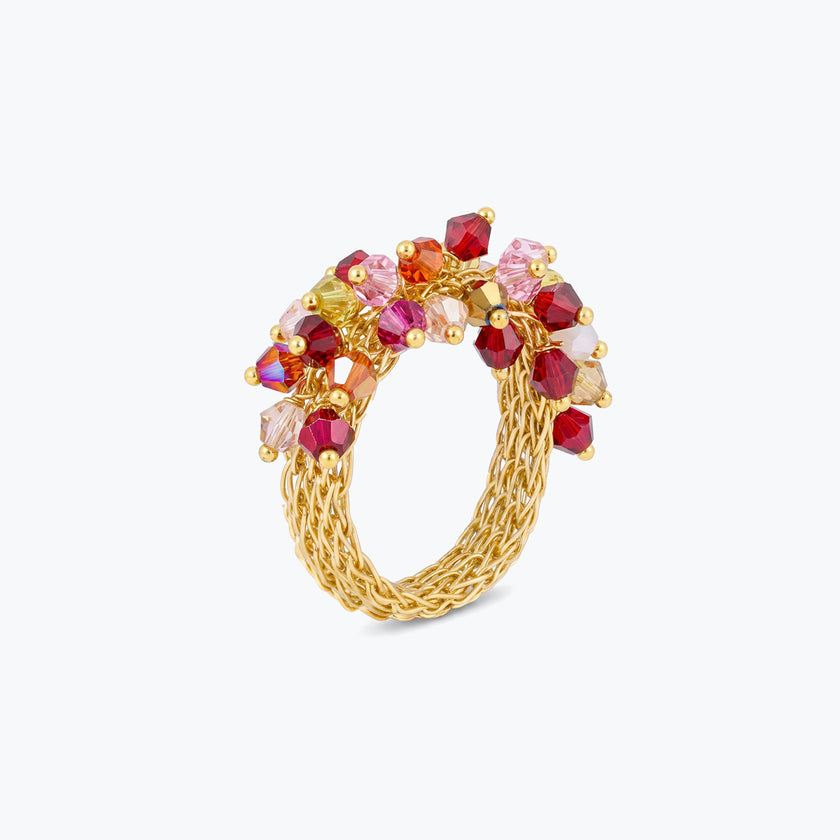 Gold ring showcasing pink and red premium crystals woven into a prominent cluster.