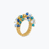 Gold statement ring featuring premium crystals in shades of blue and aqua on handknitted wire mesh.
