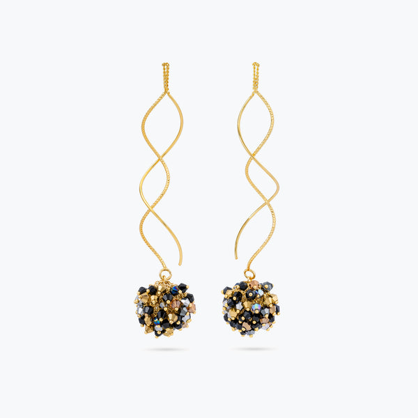 Gold twisted wire drop earrings with a sphere of reflective crystals in black, silver, and gold colors.