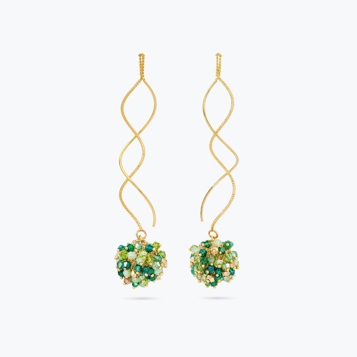 Gold spiral long earrings featuring a cluster of premium crystals in vibrant emerald and lime green hues.