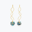 Gold spiral drop earrings with a cluster of individually hanging crystals in various shades of blue.