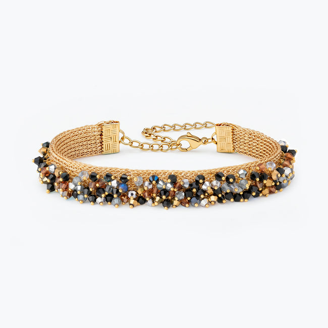 Gold handknitted wire mesh bracelet embellished with reflective crystals in black, bronze, and silver.