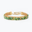 Gold handknitted wire mesh bracelet showcasing emerald, olive, and mint green premium crystals.