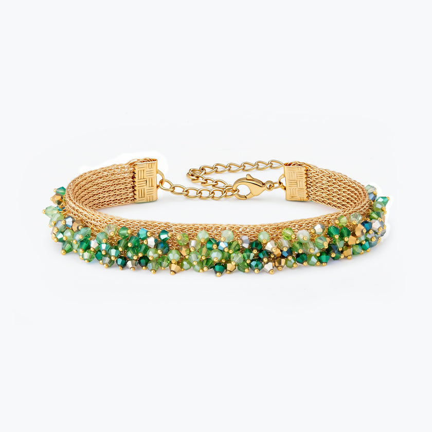Gold handknitted wire mesh bracelet showcasing emerald, olive, and mint green premium crystals.