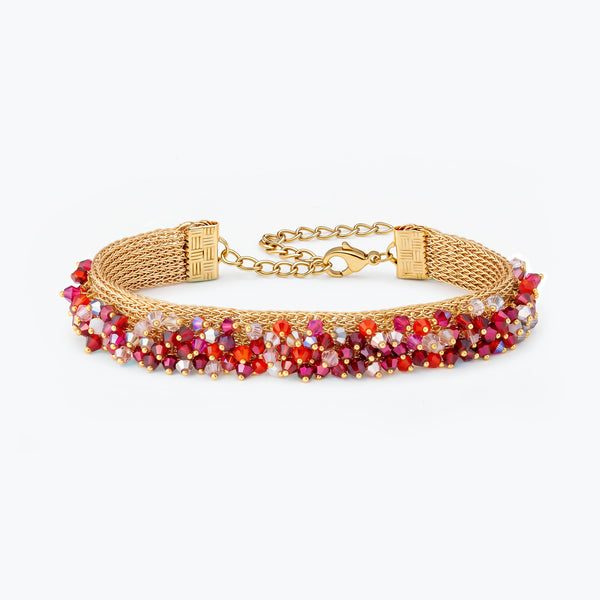 Gold handknitted wire mesh bracelet adorned with premium crystals in red and hot pink.