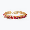 Gold handknitted wire mesh bracelet adorned with premium crystals in red and hot pink.