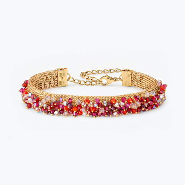 Gold handknitted wire mesh bracelet adorned with premium crystals in red and hot pink.