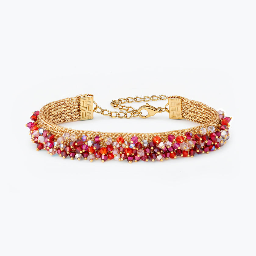 Gold handknitted wire mesh bracelet adorned with premium crystals in red and hot pink.