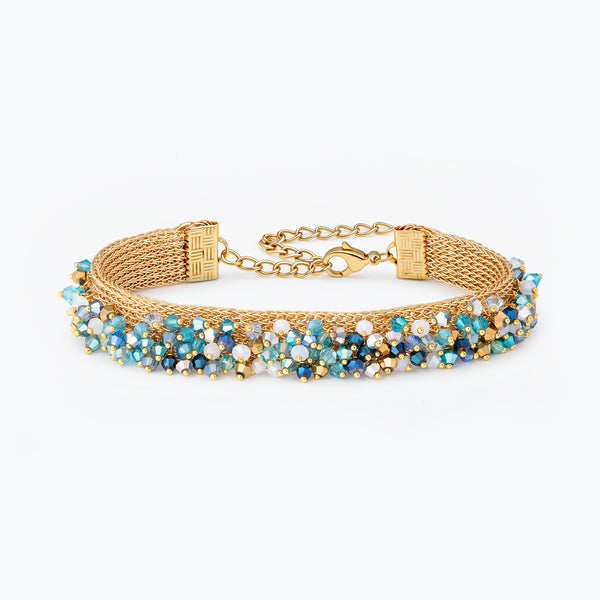Gold handknitted wire mesh bracelet featuring blue, aquamarine, and aqua premium crystals along the band.