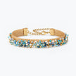 Gold handknitted wire mesh bracelet featuring blue, aquamarine, and aqua premium crystals along the band.
